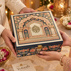 Royal Floral Arch dry fruits gift box held in hands with a Tofaah Collective card